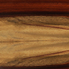 PADAUK - Padauk is found primarily in Central & tropical west Africa. It’s vivid and striking orange red coloring and open grain make for a uniquely beautiful piano unlike any other.